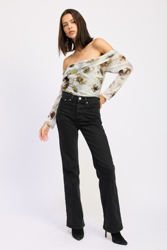 Full body view of AVAH floral mesh ruched bodysuit styled off-shoulder with straight-leg black jeans.