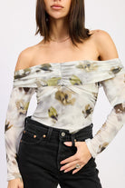 Close-up of AVAH floral off-shoulder bodysuit showing ruched neckline and mesh floral detail.