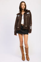 Brown floral knit collared cardigan styled with white tank, black mini skirt, and tall tan boots for a chic fall look-AVAH