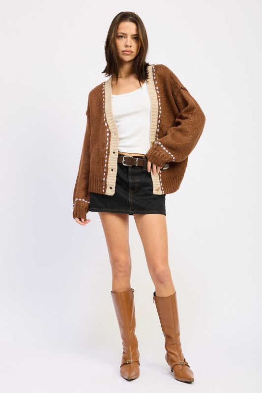 Full outfit with brown cardigan, black denim mini skirt, and tan boots.

