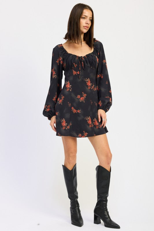 angled view of fall floral mini dress paired with black boots
