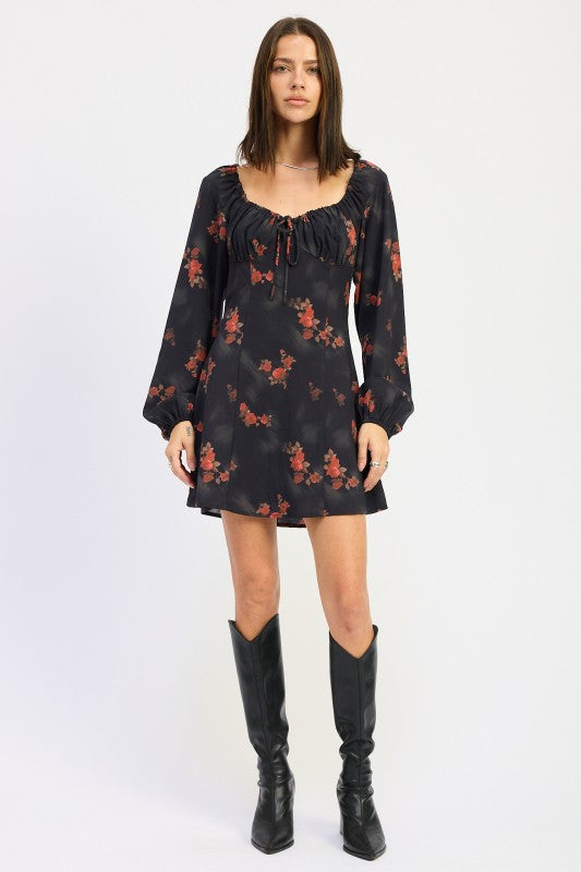 full front view of black mini dress with long sleeves and red floral print
