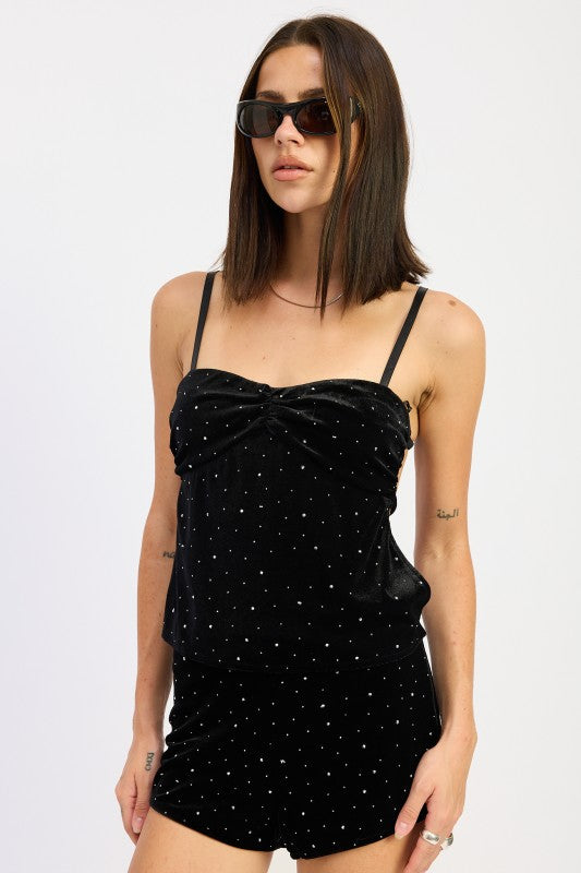 Black velvet rhinestone cami top with adjustable straps shown from a slight angle.