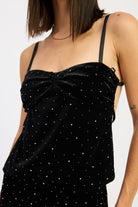 Close-up of black velvet cami top showing ruched twist neckline and scattered rhinestones.