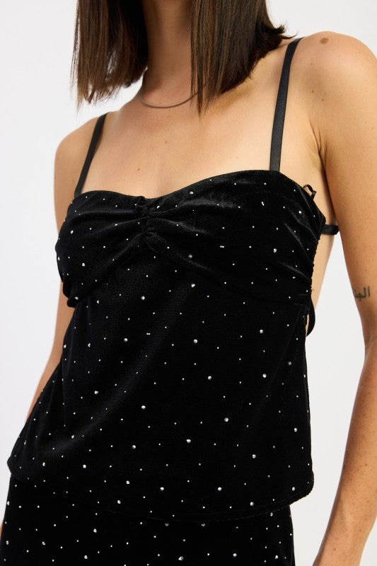 Close-up of black velvet cami top showing ruched twist neckline and scattered rhinestones.