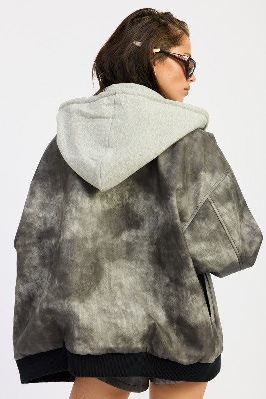 Back view of washed black mixed media jacket highlighting hood and oversized silhouette