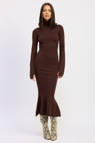 Model wearing the Sienna Whisper Open-Back Knit Dress in cocoa brown, long sleeves, turtleneck, and mermaid hem.