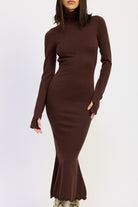 Close-up of brown knit turtleneck dress with curve-hugging fit and flared hem.