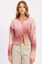 Model wearing blush ombre ribbed zip-up sweater