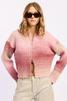 Model wearing blush ombre ribbed zip-up cardigan sweater