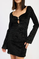 Close-up of black textured mini dress with sweetheart neckline, gold-toned clasp, and keyhole detail.