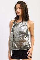 Model in black silver metallic halter top showing side angle and reflective crushed texture.