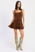full body shot of chocolate brown suede mini dress styled with snake print boots
