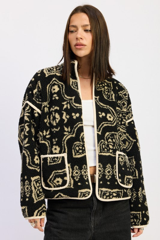 Model wearing black and taupe sherpa jacket with open front and printed design- AVAH