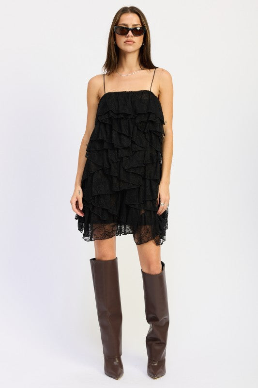 Front view of black tiered lace mini dress with ruffles and spaghetti straps.
