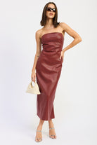 Model in burgundy strapless textured midi dress styled with sunglasses and a small ivory handbag-AVAH