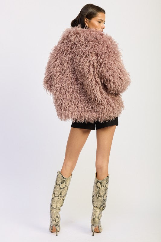 Rear angle showing the full plush texture and volume of the mauve curly pile coat.