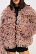 Zoomed-in view of the mauve curly textured coat showing the plush pile and collar detail.
