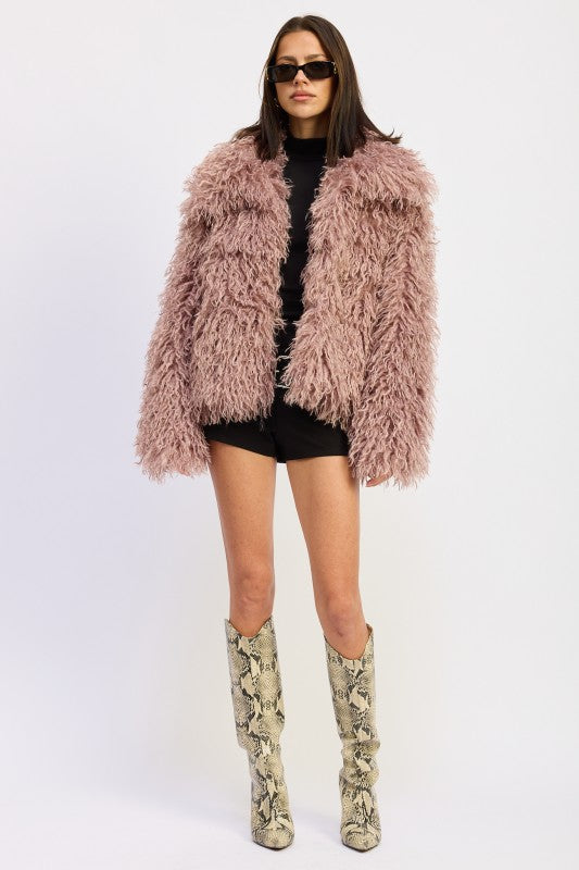 Model wearing a mauve textured statement coat with tall snakeskin boots and black base layers, front-facing-AVAH