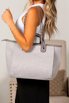 Gray canvas tote bag with clean lines, chain strap, and minimalist design