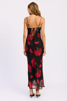 Back view of black maxi dress with red floral print, open tie-back detail, and adjustable straps-AVAH