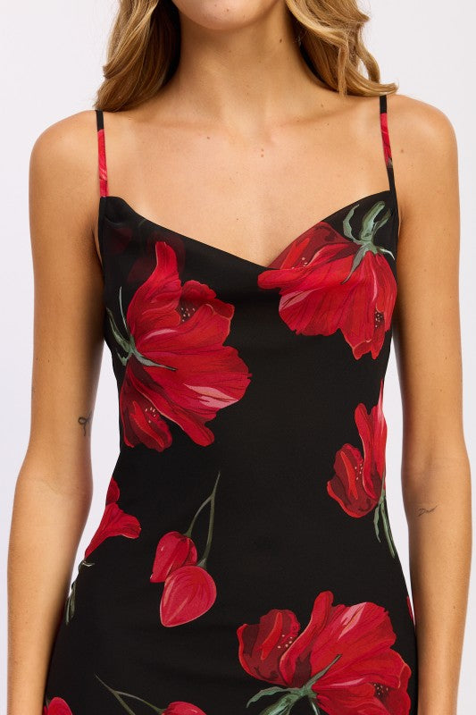 Close-up of cowl neckline and red floral print on black maxi slip dress
