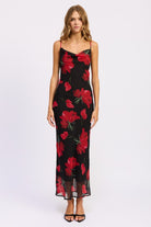 Front view of black maxi dress with bold red floral print, cowl neckline, and spaghetti straps-AVAH