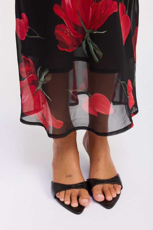 Close up of black sheer overlay with red floral pattern 