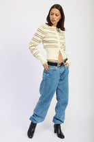 Woman wearing a striped sweater and blue jeans 