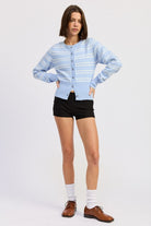 Model wearing light blue and white striped cardigan buttoned at front