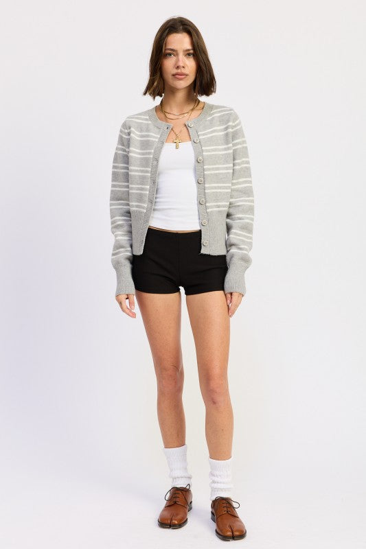 Model wearing grey and white striped button cardigan with white tank underneath