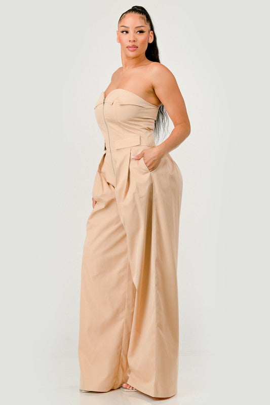 Side view of beige strapless utility jumpsuit with waist flap pockets
