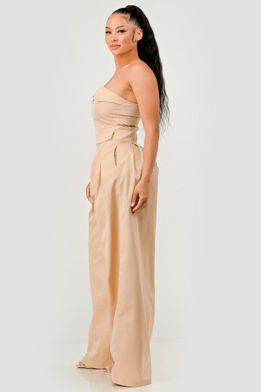 Side view of beige strapless utility jumpsuit with waist flap pockets
