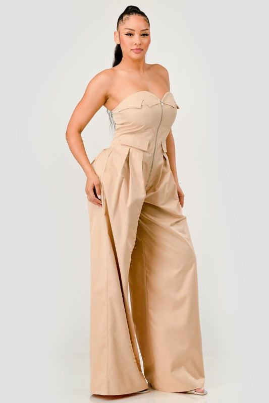 Side view of beige strapless utility jumpsuit with waist flap pockets
