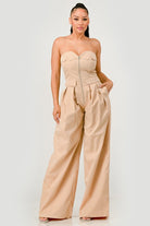 Beige strapless wide-leg jumpsuit with structured bodice, front view

