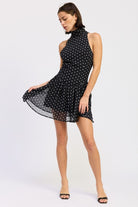 Black polka dot halter mini dress skirt movement detail
