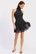 Black polka dot halter mini dress skirt movement detail
