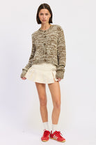 Full body front view of taupe brown knit sweater paired with cream skirt
