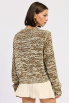 Back view of marled taupe knit sweater showing textured pattern