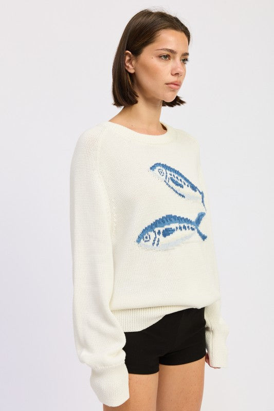 Side view of ivory cream fish knit sweater with relaxed fit
