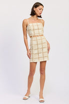 Side angle of cream lattice crochet mini dress with fitted silhouette.
