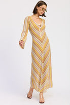Angled front view of the Sunwoven Chevron Long Sleeve Maxi Dress highlighting the long sleeves, chevron knit pattern, and relaxed drape through the skirt.