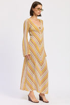 Side view of the Sunwoven Chevron Long Sleeve Maxi Dress showing the flowing maxi length, open knit texture, and softly flared sleeves.