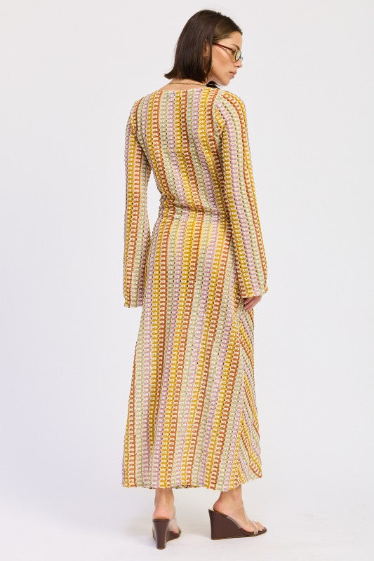 Back view of the Sunwoven Chevron Long Sleeve Maxi Dress featuring a multicolor chevron crochet-inspired knit and relaxed, fluid silhouette.