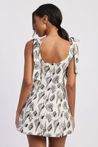 Back of seashell print mini dress featuring a scoop back and hidden zipper.