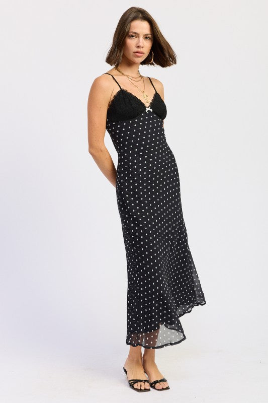 Side view of black polka dot slip dress with lace bust and fitted silhouette.
