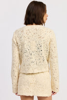 Back view of Ivory Reverie Textured Cropped Jacket highlighting detailed textured pattern and cropped fit.