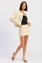 Ivory Reverie Textured Cropped Jacket in cream, styled with mini skirt and black heels for a coordinated look.