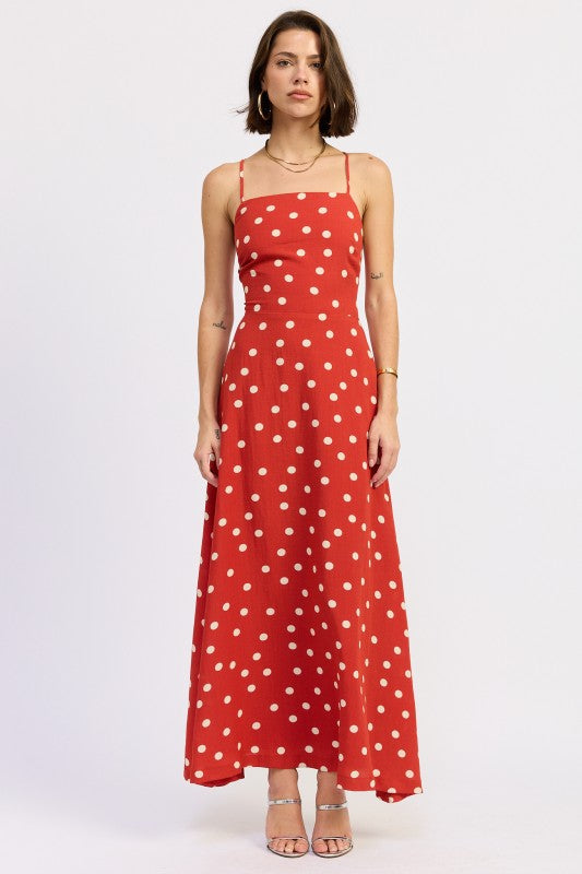 Model wearing a red polka dot maxi dress with a straight neckline and thin straps - AVAH
