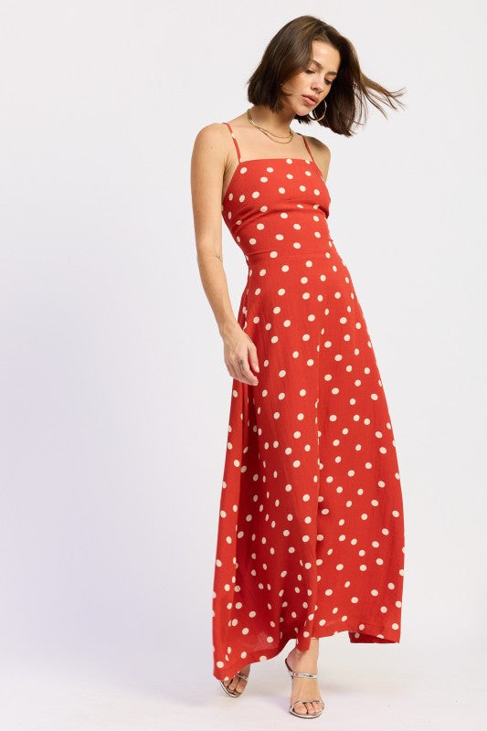 Side profile of the red polka dot maxi with fitted bodice and flared skirt.